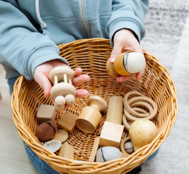 A child showing wooden Montessori materials.